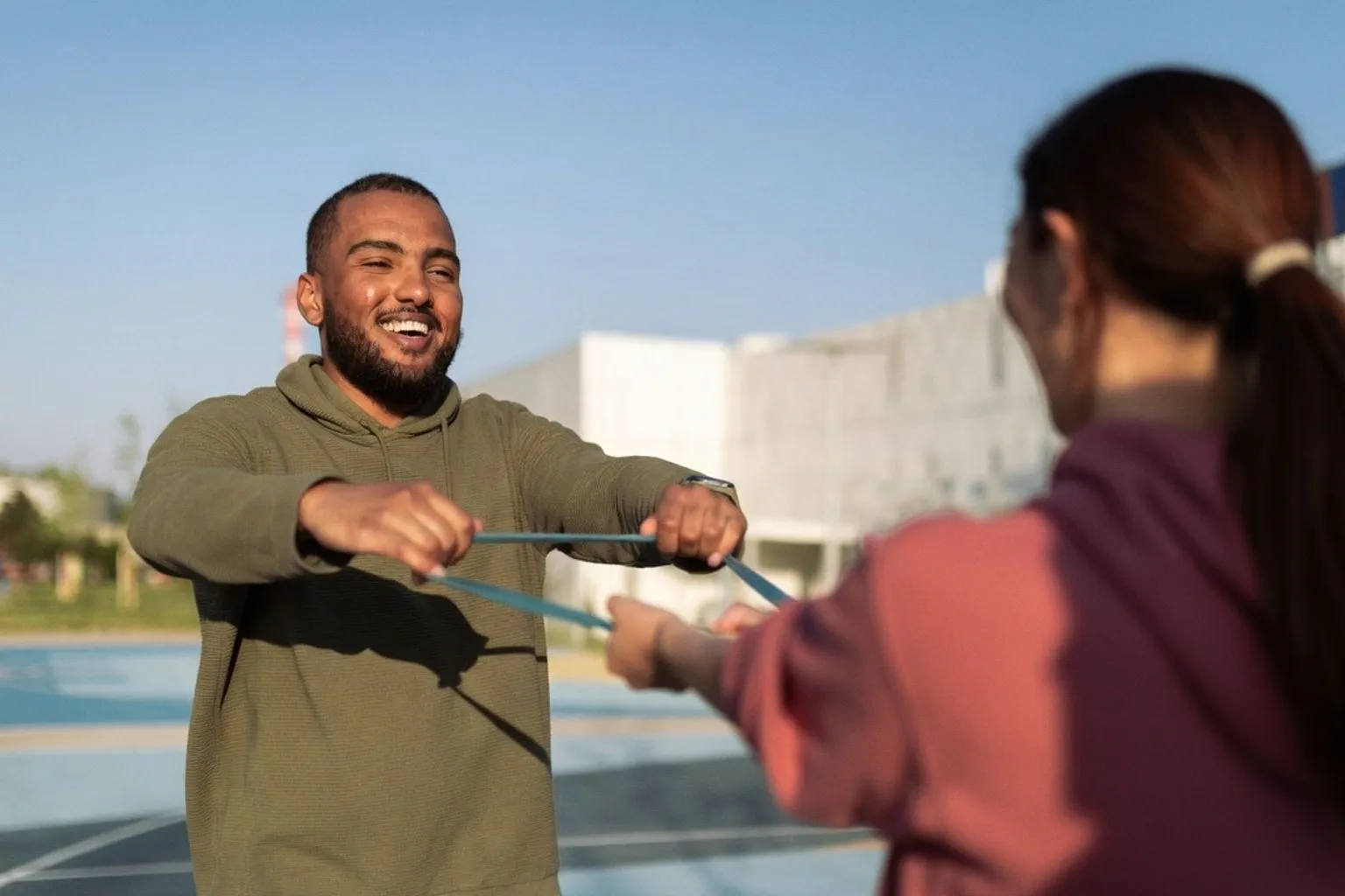 Build a Resilient Deep Core with This 12-Minute Partner Resistance Band Routine