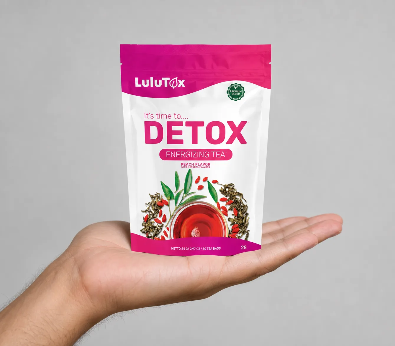 Lulutox Detox Tea HCTC — the package held in a hand